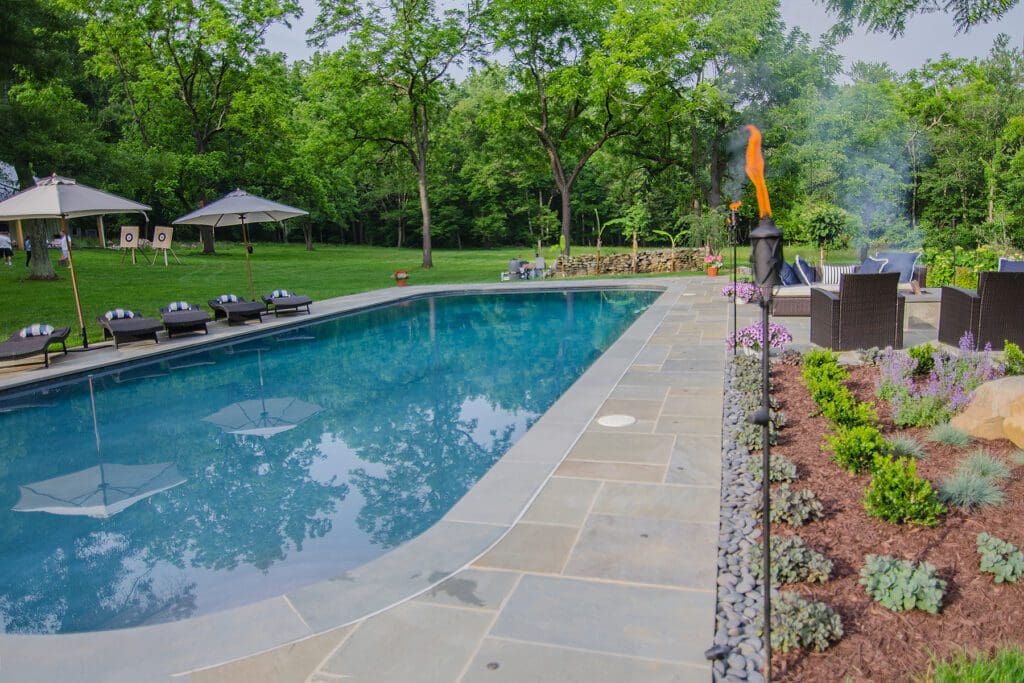 Beautiful flagstone pool deck by Dutchies