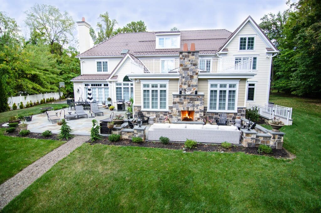 home with stone patio and fireplace