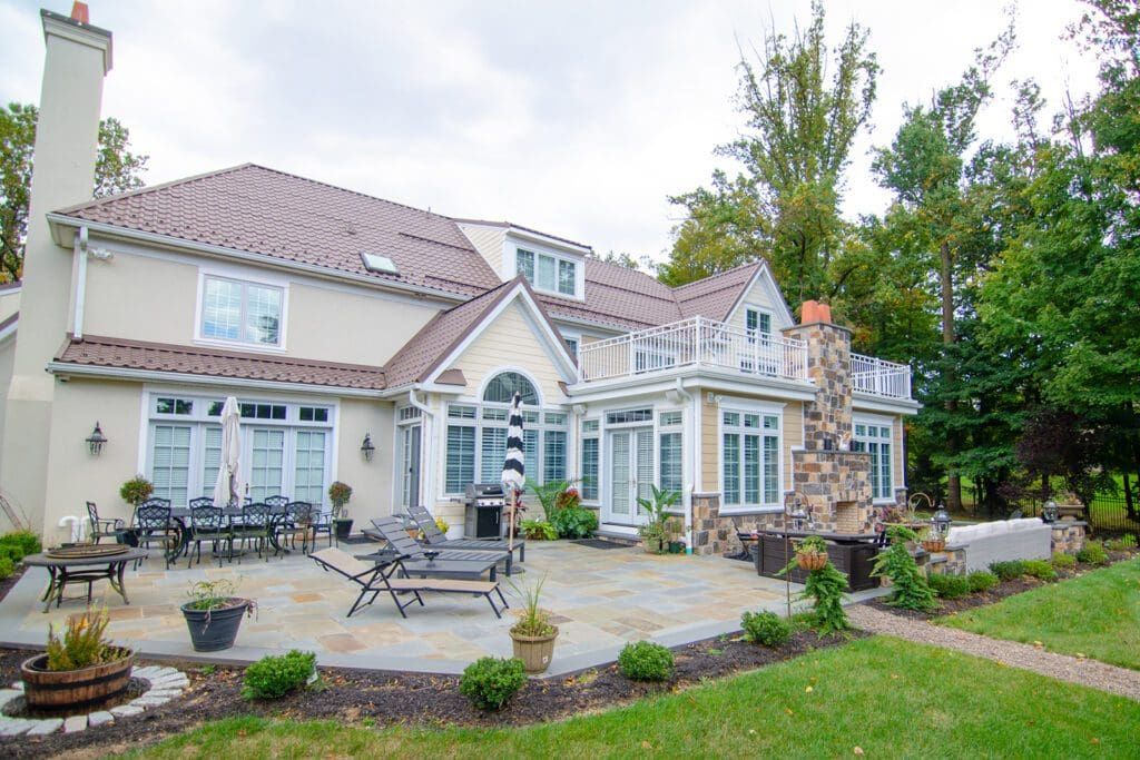 house with stone patio and fireplace
