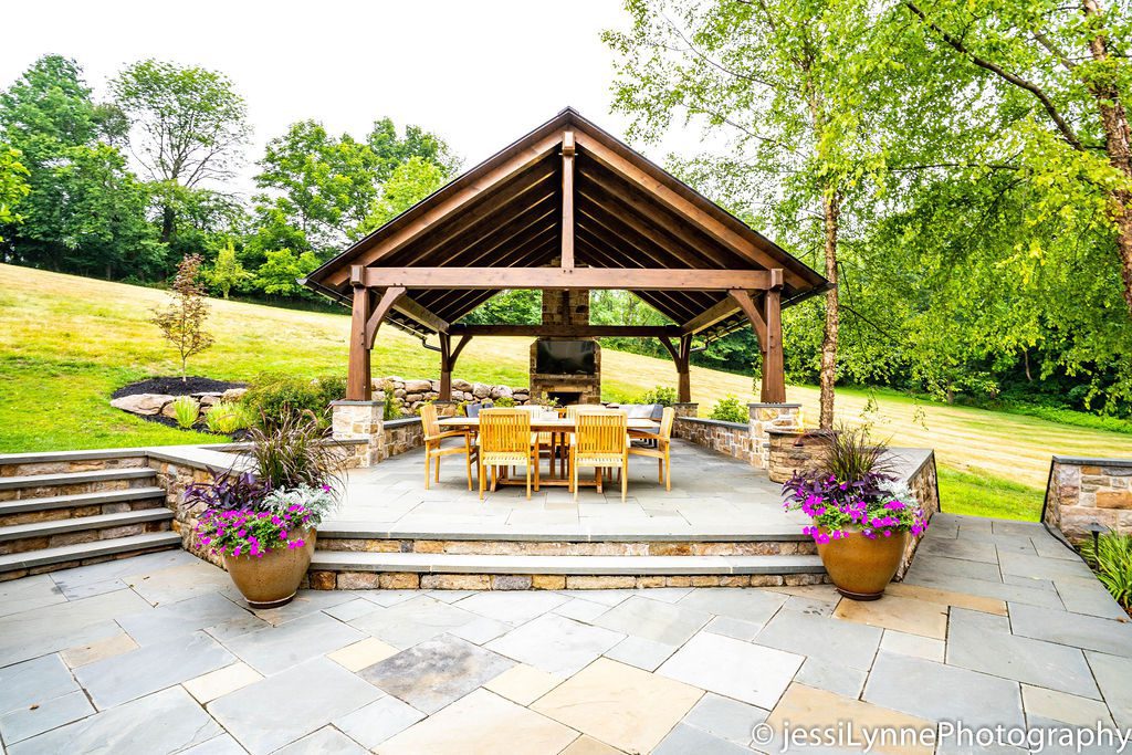 A stone patio and outdoor fireplace.