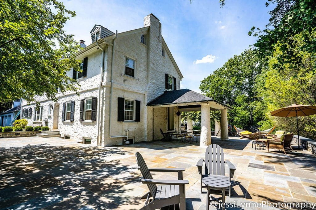 white stone home with stone deck