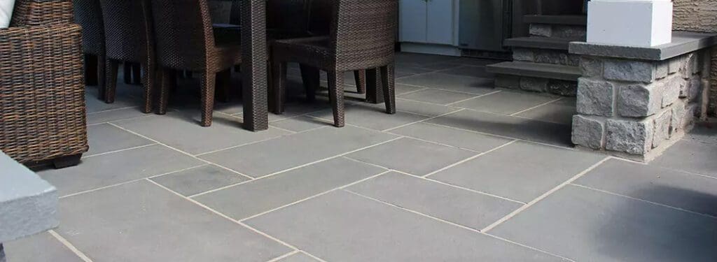 Gray stone patio with chairs and outdoor seating