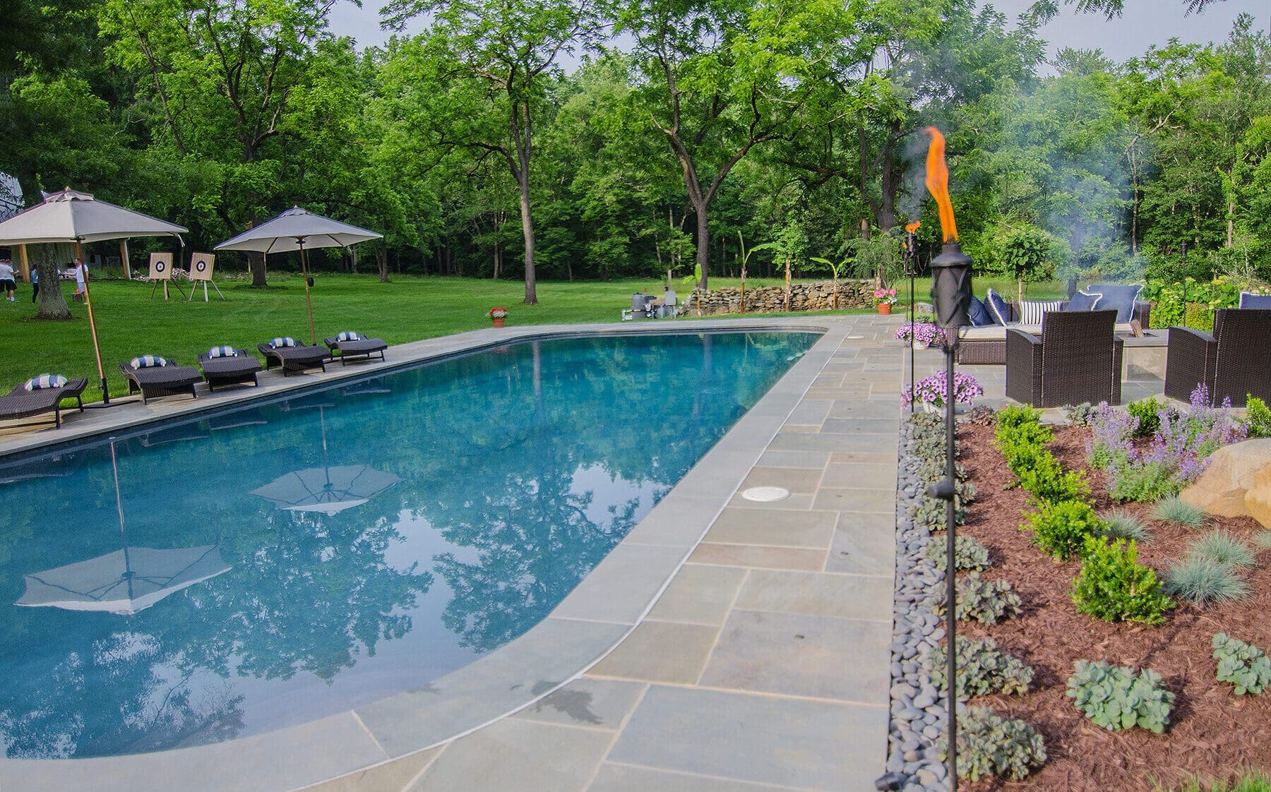 Beautiful flagstone pool deck by Dutchies