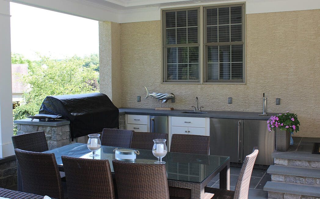 Flagstone patio and outdoor kitchen with grill, sinks, and refrigeration
