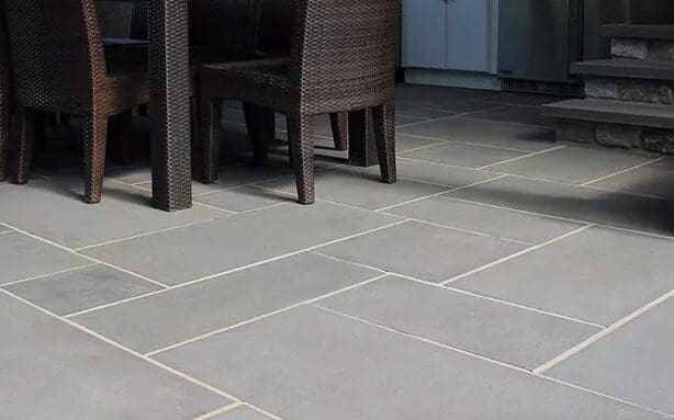 Gray stone patio with chairs and outdoor seating