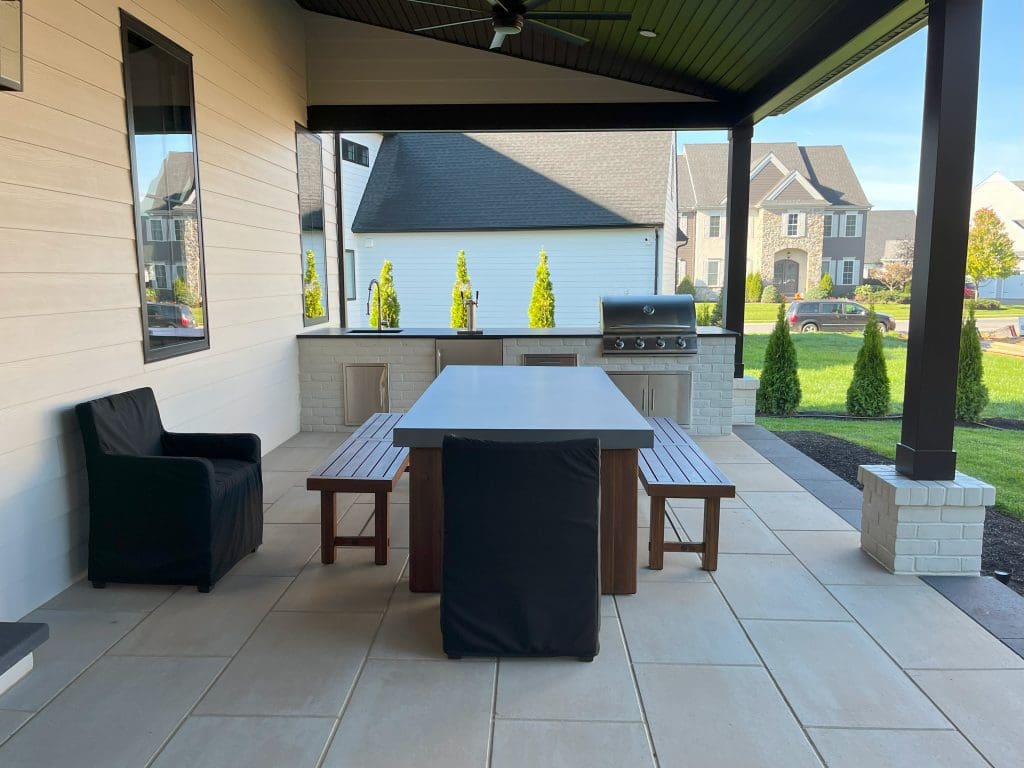 a paver patio with a table and benches