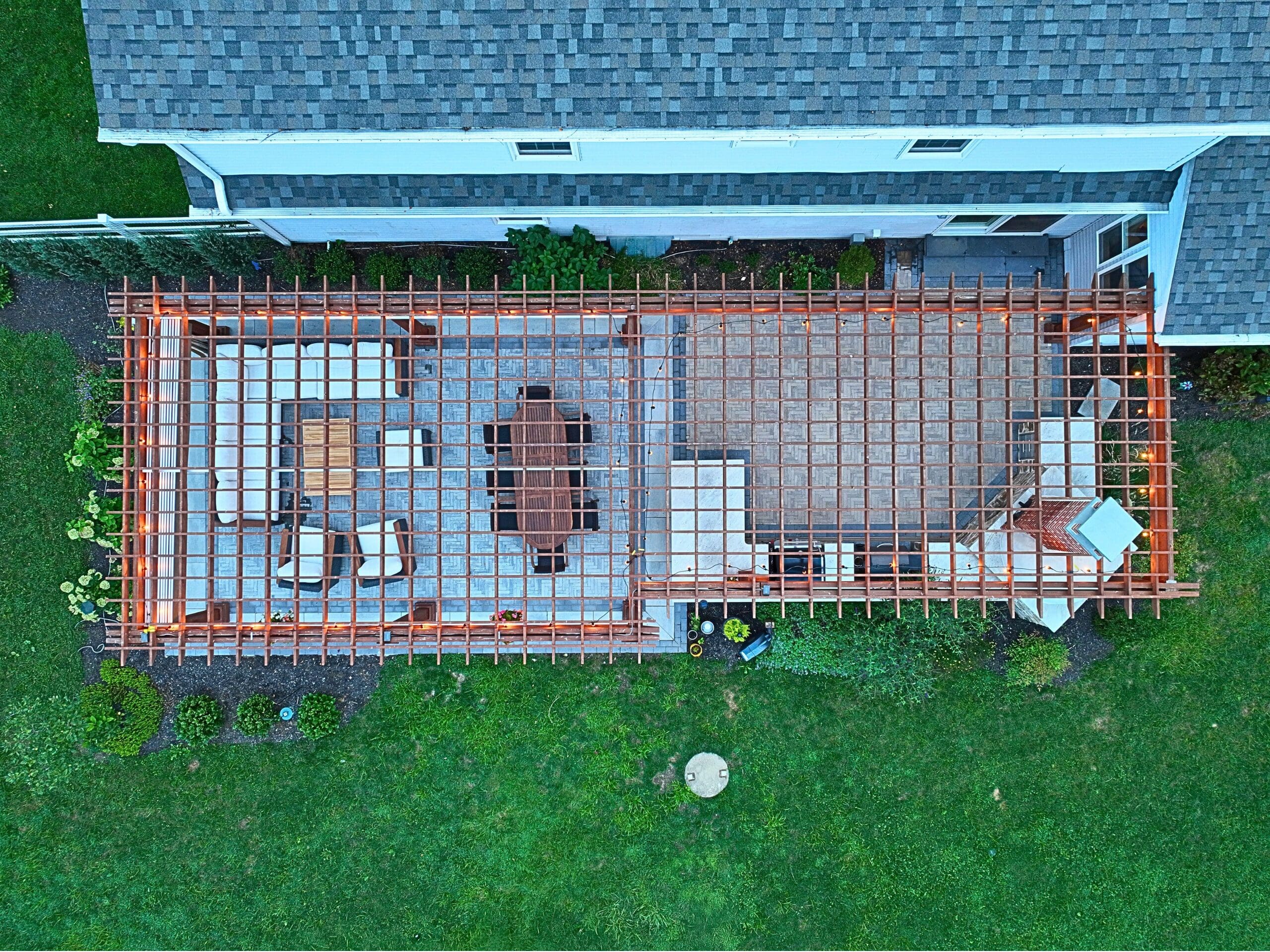 Explore this custom outdoor kitchen and pergola transformation featuring an integrated masonry pizza oven, Blaze appliances, and a Techo-Bloc Westmount paver patio