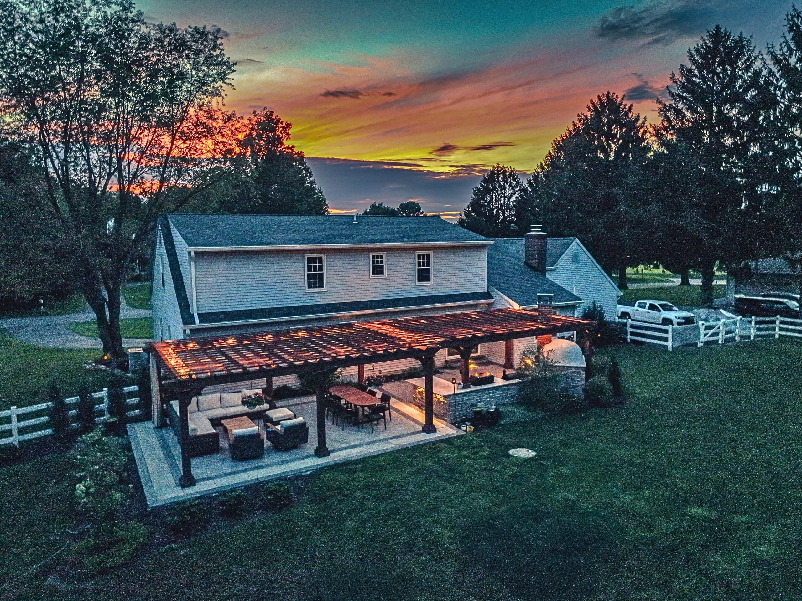 Explore this custom outdoor kitchen and pergola transformation featuring an integrated masonry pizza oven, Blaze appliances, and a Techo-Bloc Westmount paver patio