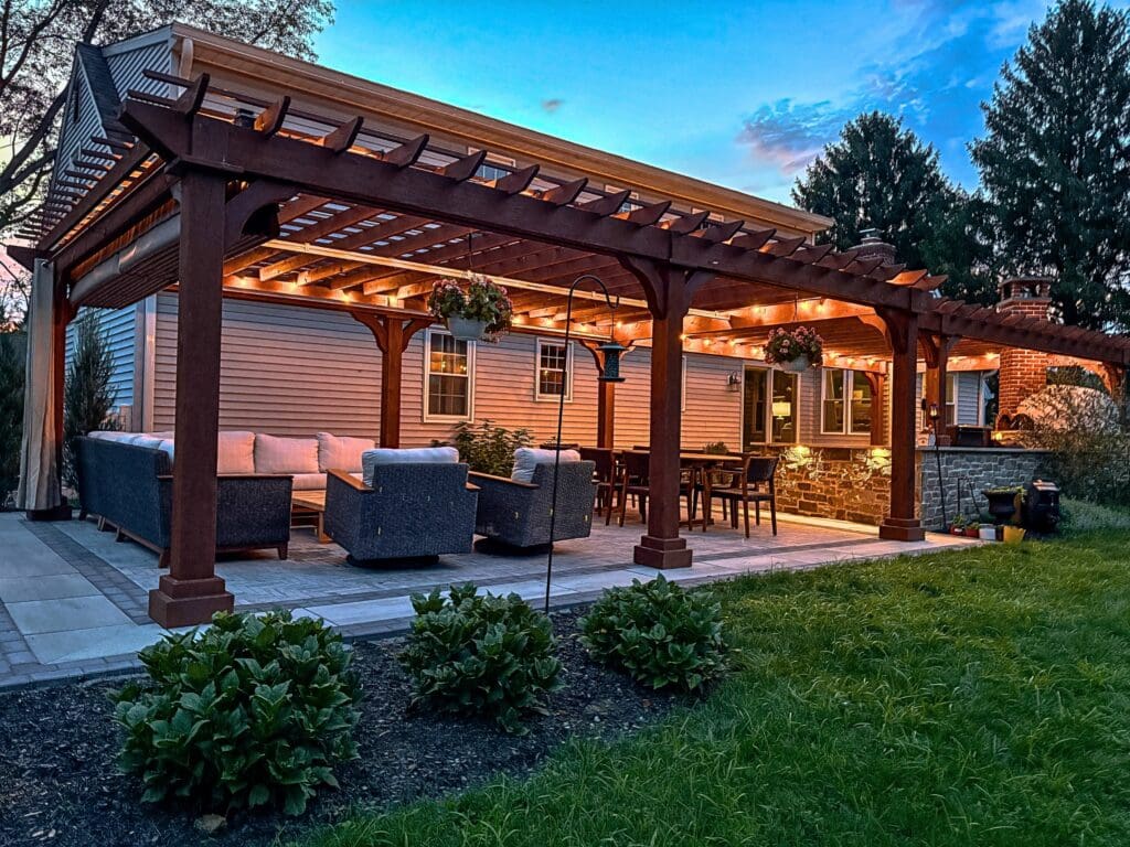 Explore this custom outdoor kitchen and pergola transformation featuring an integrated masonry pizza oven, Blaze appliances, and a Techo-Bloc Westmount paver patio
