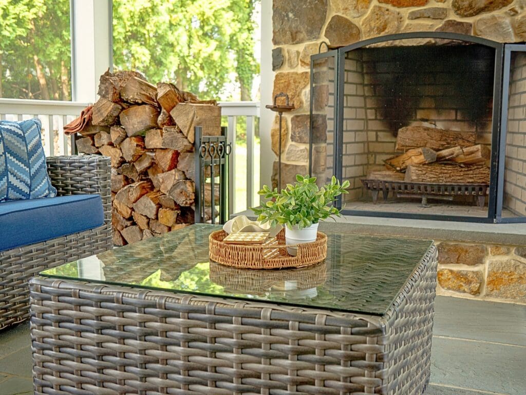 Explore this custom outdoor living transformation featuring an AZEK screened porch, Chester County natural stone fireplace, flagstone patio, and TimberTech composite deck.