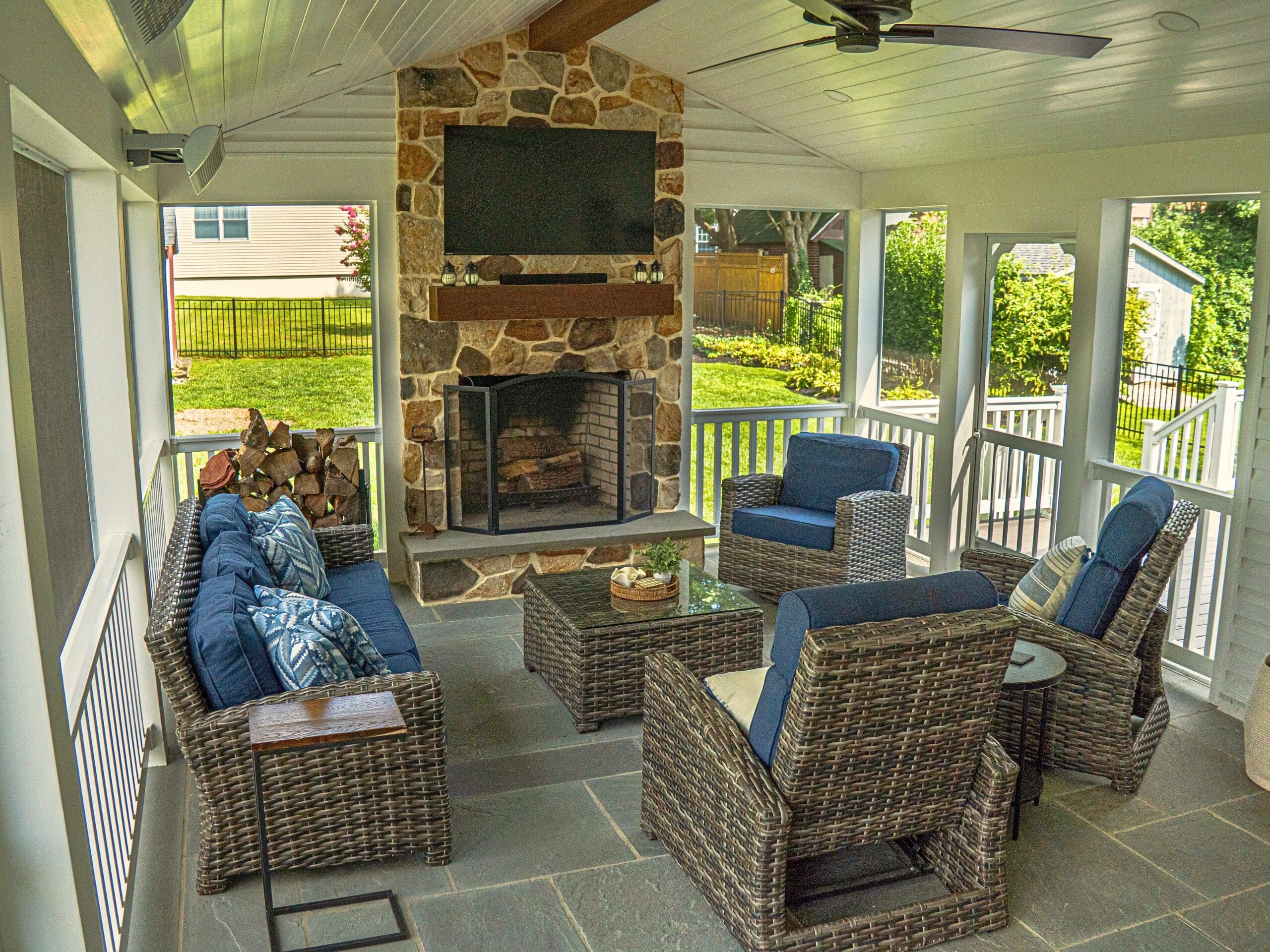 Explore this custom outdoor living transformation featuring an AZEK screened porch, Chester County natural stone fireplace, flagstone patio, and TimberTech composite deck.